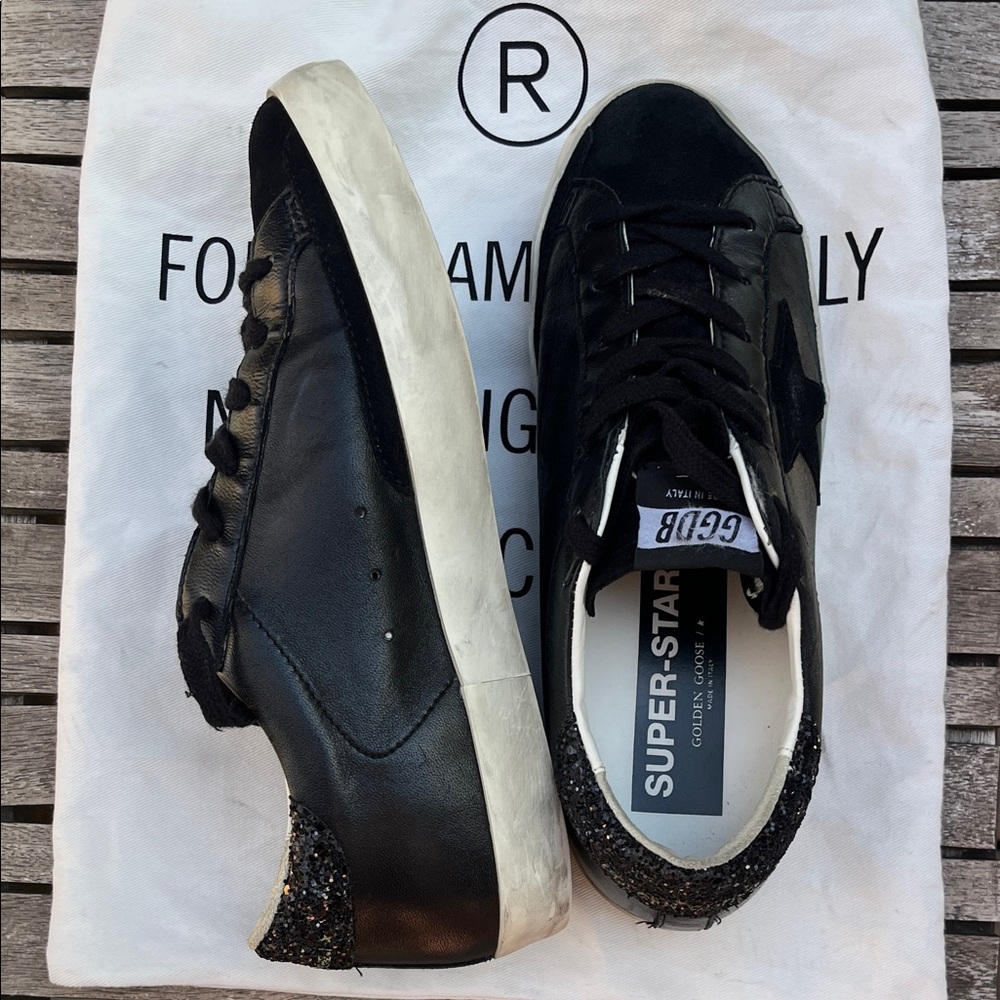 Golden Goose Women's Super-Star Black Nappa Sneakers with Glitter Heel Tab.